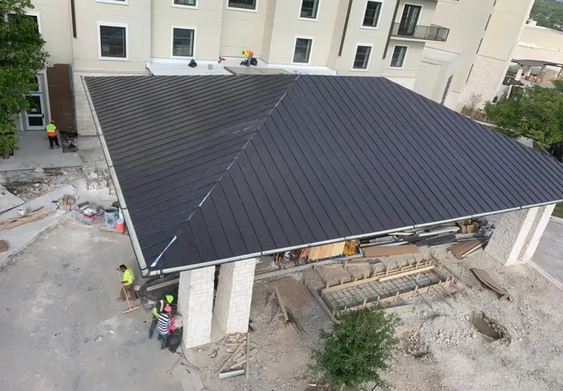 Metal roofing installation team working on a commercial building in West Valley City